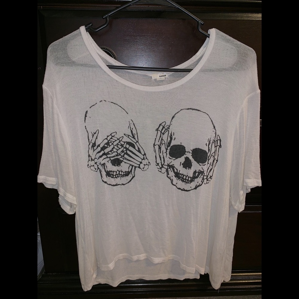 White flowy top with “hear/see no evil” skeletons